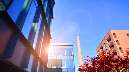View of an modern apartment building standing next to a new modern office building with a glass...
