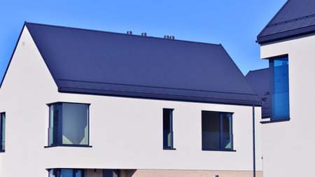 New elegant modern single family house. Terraced family homes in newly developed housing estate. Facade of a modern house with white walls. Real estate concept, european style.の写真素材