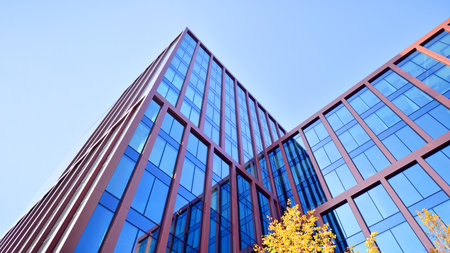 Sustainable glass office building with trees for reducing carbon dioxide. Eco-friendly building in...