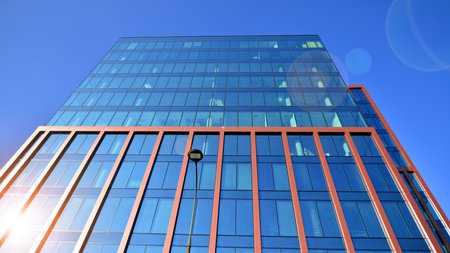 Modern stylish architecture. Symmetrical blue glass building in the city. Cityscape office buildings...