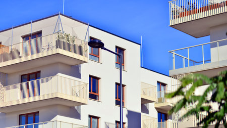 Modern apartment buildings on a sunny day with a blue sky. Facade of a modern apartment building. Contemporary residential building exterior in the daylight.の写真素材