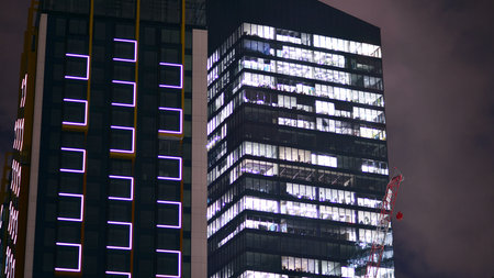 Night architecture, skyscrapers with glass facade. Modern buildings in business district. Concept of economics, financial.の写真素材