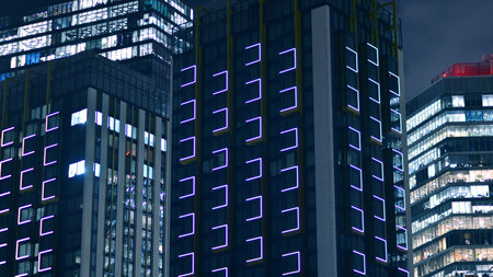 Night architecture, skyscrapers with glass facade. Modern buildings in business district. Concept of economics, financial.の写真素材