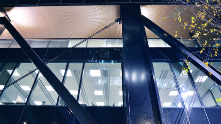 A modern architectural design intricately with details. Night lights casting reflections, capturing the essence of contemporary art and advanced engineering.の写真素材