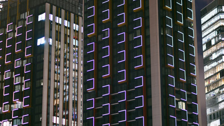 Night architecture, skyscrapers with glass facade. Modern buildings in business district. Concept of economics, financial.の写真素材