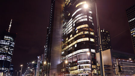 Night architecture, skyscrapers with glass facade. Modern buildings in business district. Concept of...