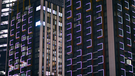 Night architecture, skyscrapers with glass facade. Modern buildings in business district. Concept of economics, financial.の写真素材