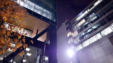 A modern architectural design intricately with details. Night lights casting reflections, capturing the essence of contemporary art and advanced engineering.の写真素材