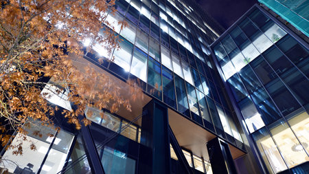 A modern architectural design intricately with details. Night lights casting reflections, capturing the essence of contemporary art and advanced engineering.の写真素材