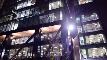 A modern architectural design intricately with details. Night lights casting reflections, capturing the essence of contemporary art and advanced engineering.の写真素材