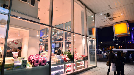 Warsaw, Poland. 22 November 2024. Street photography of people on the street at night. The pedestrian silhouettes on the modern building background. Motion blur of people. Urbanのeditorial素材