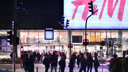 Warsaw, Poland. 22 November 2024. Street of a big city. People of different ages crossing the road through. View of a city street with residents, tourists and modern buildings.のeditorial素材