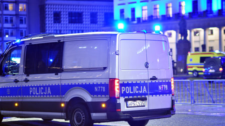 Warsaw, Poland. 3 January 2025. Police car on patrol with blue lights on the street in the night.のeditorial素材