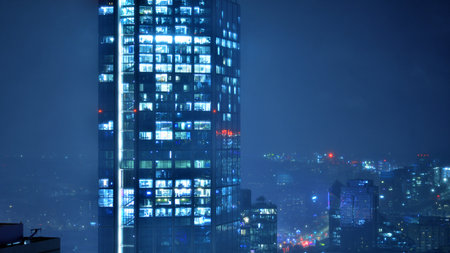 Aerial photography of modern architectural landscapes in the fog at night. Lights in the windows of buildings. The blue color of twilight.の写真素材
