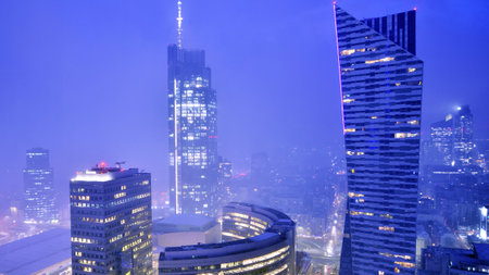 Aerial photography of modern architectural landscapes in the fog at night. Lights in the windows of buildings. The blue color of twilight.の写真素材
