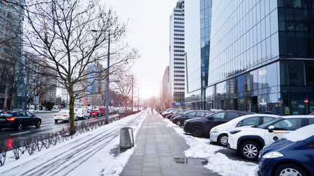 Warsaw, Poland. 12 January 2025. Winter street of a big city. Street photography. Cars parked in the snow covered lot street in winter day. Lifestyle of the city.のeditorial素材