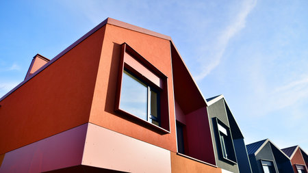 Terraced family homes in newly developed housing estate. The real estate market in the suburbs. New single family houses in a new development area. Residential homes with modern faの写真素材