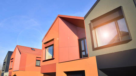 Terraced family homes in newly developed housing estate. The real estate market in the suburbs. New single family houses in a new development area. Residential homes with modern faの写真素材