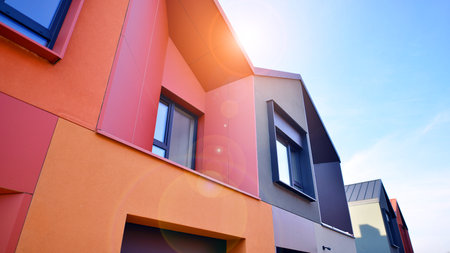 Terraced family homes in newly developed housing estate. The real estate market in the suburbs. New single family houses in a new development area. Residential homes with modern faの写真素材