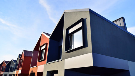 Terraced family homes in newly developed housing estate. The real estate market in the suburbs. New single family houses in a new development area. Residential homes with modern faの写真素材