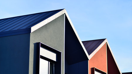 Terraced family homes in newly developed housing estate. The real estate market in the suburbs. New single family houses in a new development area. Residential homes with modern faの写真素材