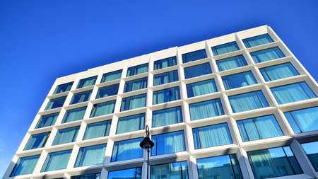 Large glass windows in a modern hotel building. Modern urban architecture. Large expansions of glass in concrete wall panels.の写真素材