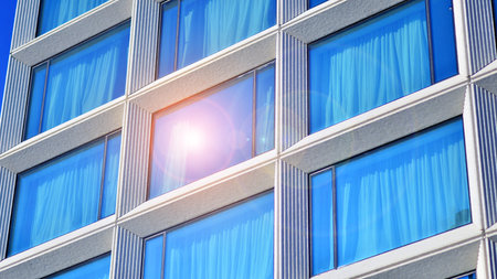 Large glass windows in a modern hotel building. Modern urban architecture. Large expansions of glass in concrete wall panels.の写真素材