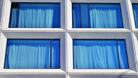 Large glass windows in a modern hotel building. Modern urban architecture. Large expansions of glass in concrete wall panels.の写真素材