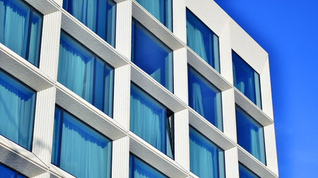 Large glass windows in a modern hotel building. Modern urban architecture. Large expansions of glass in concrete wall panels.の写真素材