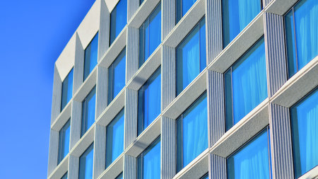 Large glass windows in a modern hotel building. Modern urban architecture. Large expansions of glass in concrete wall panels.の写真素材