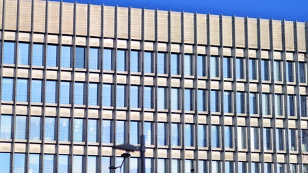 Reflection of a modern office building in the windows of a skyscraperの写真素材