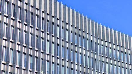 Facade fragment of a modern office building. Exterior of glass wall with abstract texture.の写真素材
