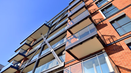 Modern apartment buildings on a sunny day with a blue sky. Facade of a modern apartment building