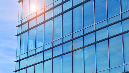 Modern stylish architecture. Symmetrical blue glass building in the city. Cityscape office buildings with modern corporate architecture - business and success concept.の写真素材