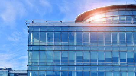 Modern stylish architecture. Symmetrical blue glass building in the city. Cityscape office buildings with modern corporate architecture - business and success concept.の写真素材