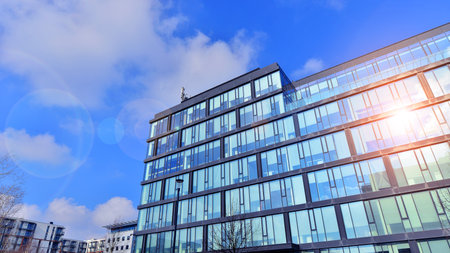 Cityscape office buildings with modern corporate architecture - business and success concept. Modern stylish architecture. Symmetrical blue glass building in the city.の写真素材