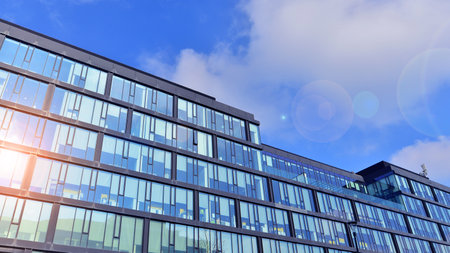 Cityscape office buildings with modern corporate architecture - business and success concept. Modern stylish architecture. Symmetrical blue glass building in the city.の写真素材