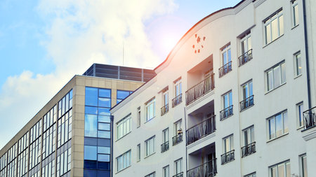 View of an modern apartment building standing next to a new modern office building with a glass facade.の写真素材