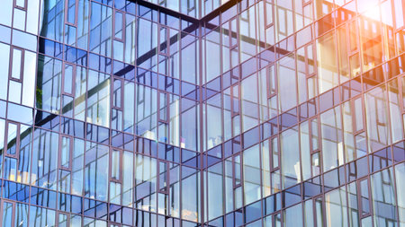 Cityscape office buildings with modern corporate architecture - business and success concept. Modern stylish architecture. Symmetrical blue glass building in the city.の写真素材