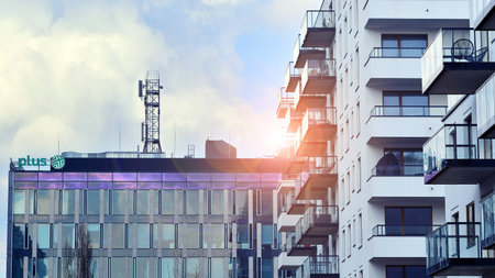 Warsaw, Poland. February 20, 2025. Urban landscape. Company signboard Plus. Neon sign with the...