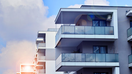 Modern and new apartment building. Multistory modern, new and stylish living block of flats.の写真素材