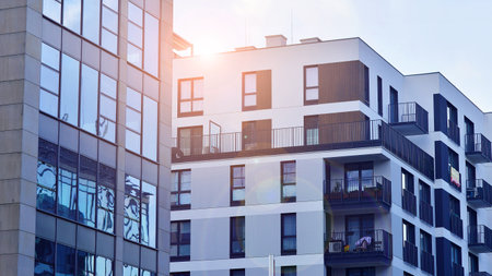 View of an modern apartment building standing next to a new modern office building with a glass facade.の写真素材