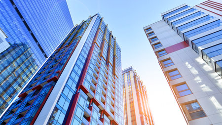View of an modern apartment building standing next to a new modern office building with a glass facade.の写真素材