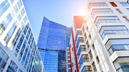 View of an modern apartment building standing next to a new modern office building with a glass facade.の写真素材