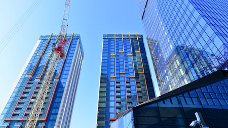 Crane on the construction site in a site surrounded by the high buildings.の写真素材