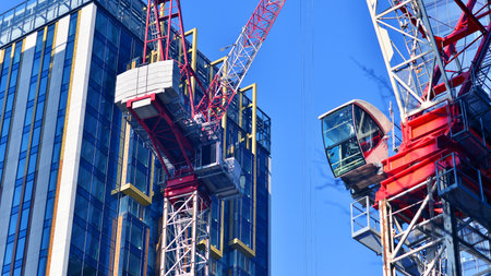 Crane on the construction site in a site surrounded by the high buildings.の写真素材