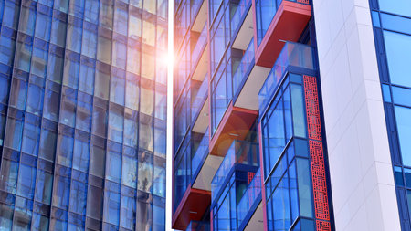 View of an modern apartment building standing next to a new modern office building with a glass facade.の写真素材