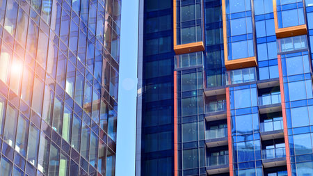 View of an modern apartment building standing next to a new modern office building with a glass facade.の写真素材