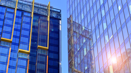 View of an modern apartment building standing next to a new modern office building with a glass facade.の写真素材