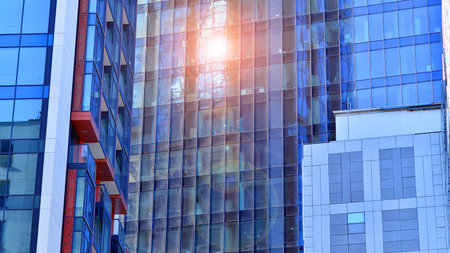 View of an modern apartment building standing next to a new modern office building with a glass facade.の写真素材